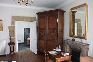 Exposed stone walls and antique furniture