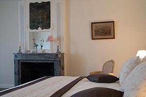 Bedroom with marble fireplace