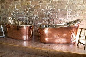 Luxury hotel room with twin copper bath tubs