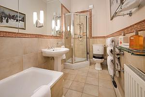 En-suite bathroom with bath and shower