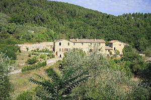 Small Tuscany hotel surrounded by trees and fields
