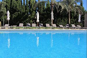 Swimming pool with sunbeds and umbrellas